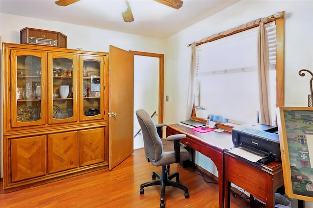 home office featuring light wood-type flooring and a ceiling fan