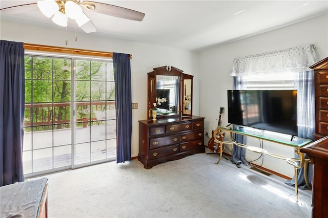 sitting room with carpet floors, a ceiling fan, and visible vents