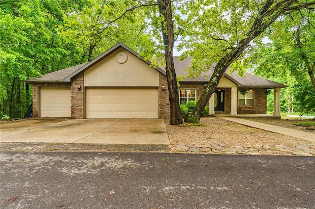 2 Saxilby Ln, Bella Vista, AR 72715 - view of front of house featuring brick siding, a garage, driveway, and a shingled roof