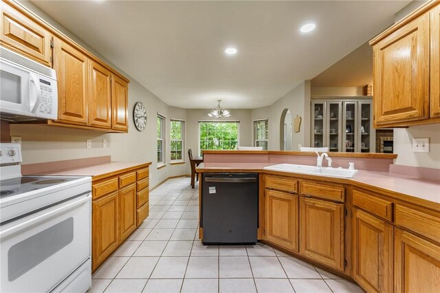 2 Saxilby Ln, Bella Vista, AR 72715 - kitchen featuring an inviting chandelier, a peninsula, white appliances, light countertops, and a sink