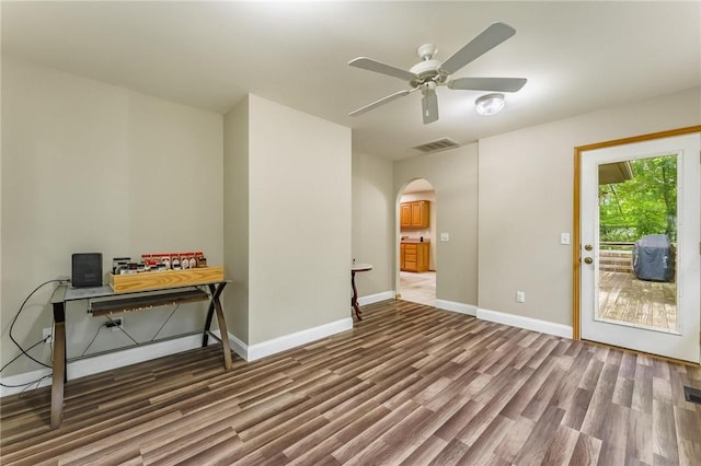 2 Saxilby Ln, Bella Vista, AR 72715 - unfurnished room with ceiling fan, arched walkways, baseboards, wood finished floors, and visible vents