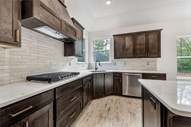 4 Lothian Dr, Bella Vista, AR 72715 - kitchen featuring stainless steel appliances, a sink, custom range hood, and dark brown cabinets