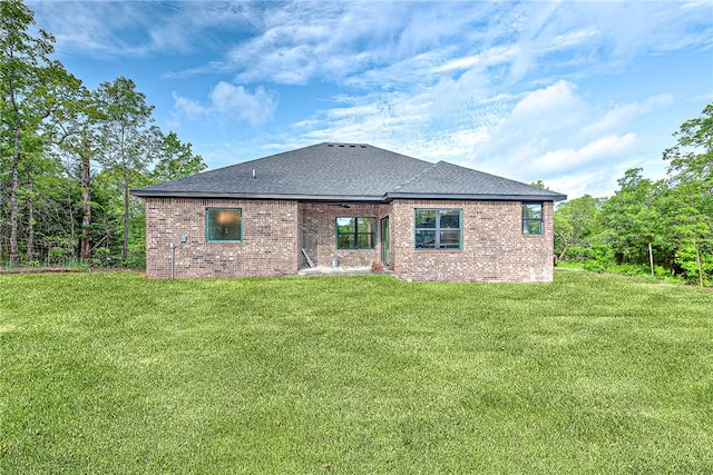 4 Lothian Dr, Bella Vista, AR 72715 - rear view of house with a yard, brick siding, and roof with shingles