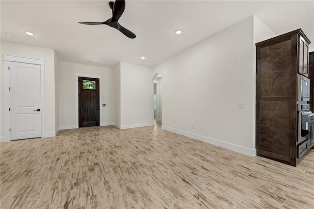 4 Lothian Dr, Bella Vista, AR 72715 - unfurnished living room featuring ceiling fan, light wood-style floors, arched walkways, baseboards, and recessed lighting