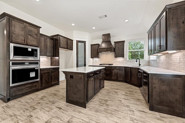 4 Lothian Dr, Bella Vista, AR 72715 - kitchen featuring stainless steel appliances, premium range hood, a sink, tasteful backsplash, and a kitchen island