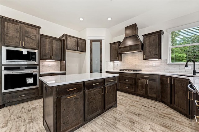 4 Lothian Dr, Bella Vista, AR 72715 - kitchen with stainless steel appliances, custom exhaust hood, a sink, light countertops, and decorative backsplash