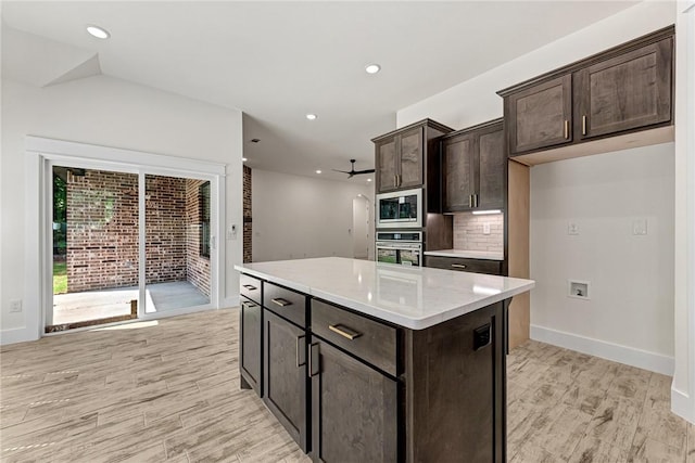 4 Lothian Dr, Bella Vista, AR 72715 - kitchen with stainless steel appliances, dark brown cabinets, light wood-style floors, backsplash, and a center island