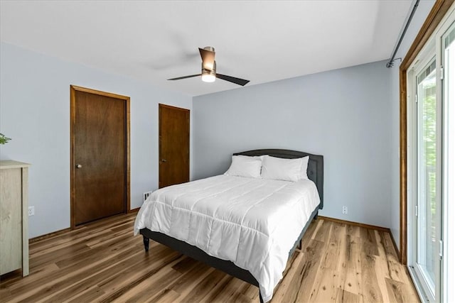 bedroom with multiple closets, a ceiling fan, and light wood-type flooring