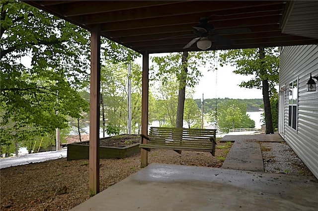 view of patio featuring a ceiling fan and a water view