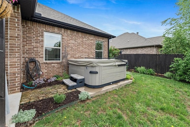 exterior space featuring a hot tub and fence