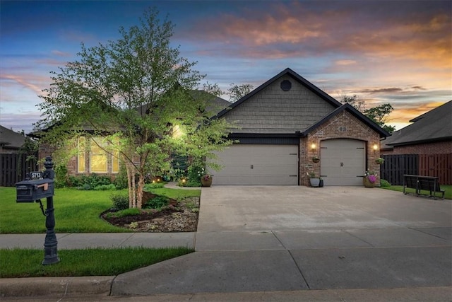 craftsman-style home featuring fence, brick siding, a garage, a front yard, and driveway