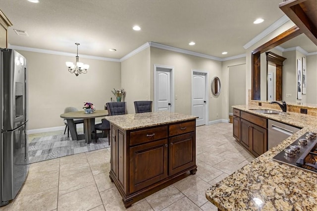 kitchen featuring an inviting chandelier, baseboards, a center island, a sink, and appliances with stainless steel finishes