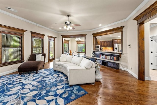 living room featuring visible vents, baseboards, ceiling fan, and wood finished floors