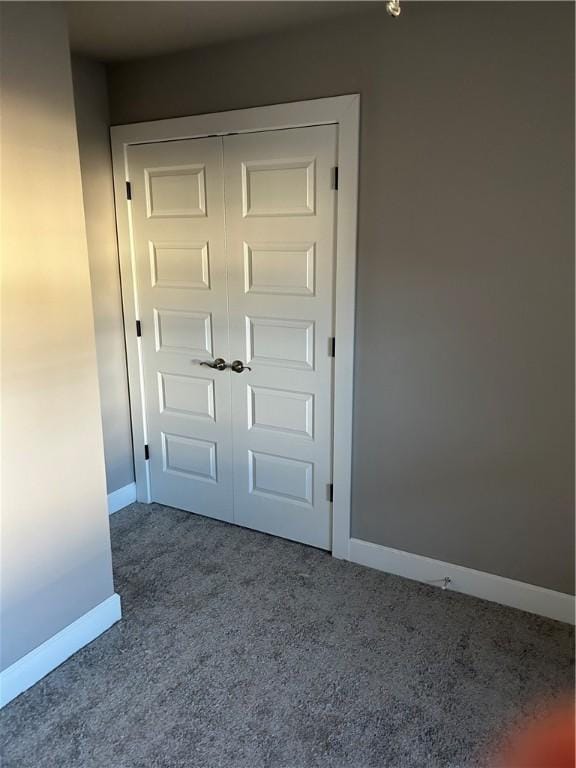 interior space with carpet floors and baseboards