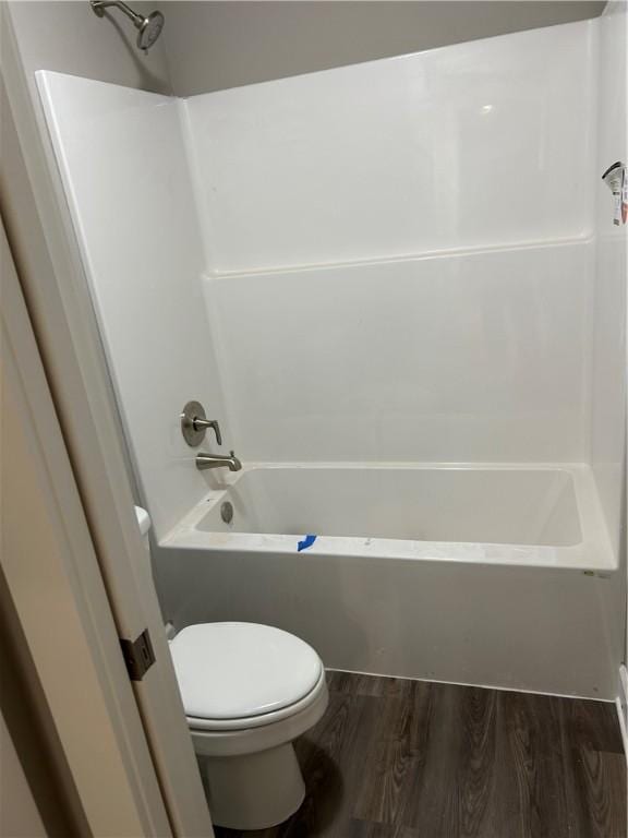 full bathroom with toilet, wood finished floors, and  shower combination