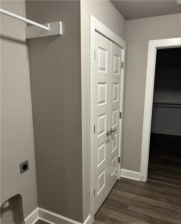 washroom with baseboards, dark wood-style flooring, laundry area, and electric dryer hookup