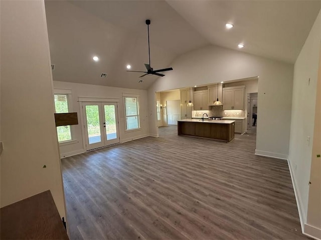 unfurnished living room featuring a sink, high vaulted ceiling, ceiling fan, and dark wood-style flooring