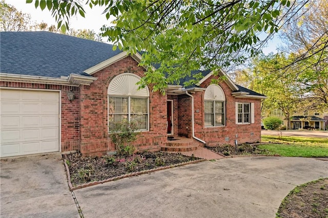 ranch-style home featuring brick siding, a shingled roof, an attached garage, and driveway