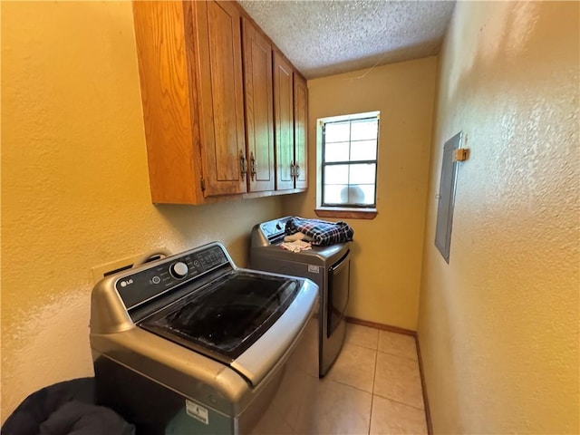 60 N Redwood Cir, Sallisaw, OK 74955 - laundry area featuring electric panel, a textured ceiling, cabinet space, separate washer and dryer, and a textured wall