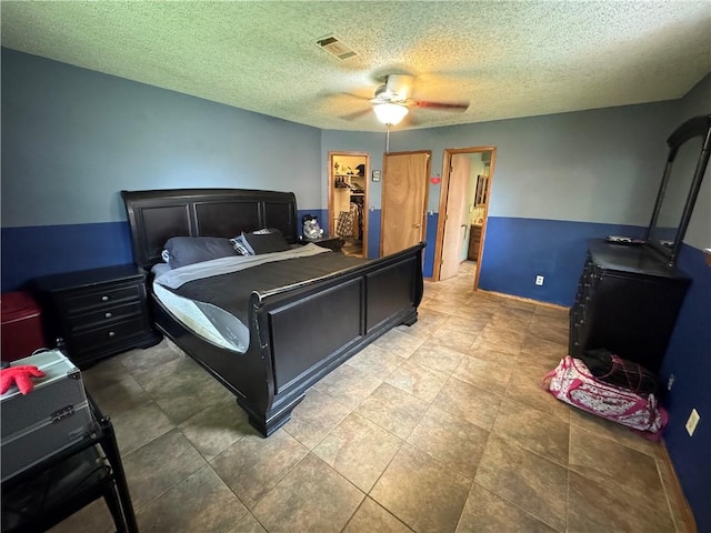 60 N Redwood Cir, Sallisaw, OK 74955 - bedroom featuring a walk in closet, ceiling fan, a textured ceiling, visible vents, and a closet