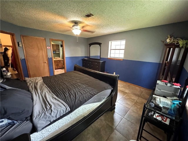 60 N Redwood Cir, Sallisaw, OK 74955 - bedroom with visible vents, a ceiling fan, a textured ceiling, and ensuite bathroom