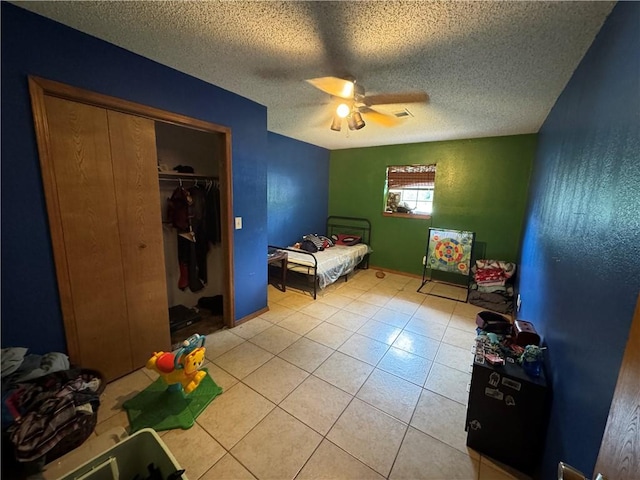 60 N Redwood Cir, Sallisaw, OK 74955 - bedroom with a closet, a textured ceiling, ceiling fan, and light tile patterned floors