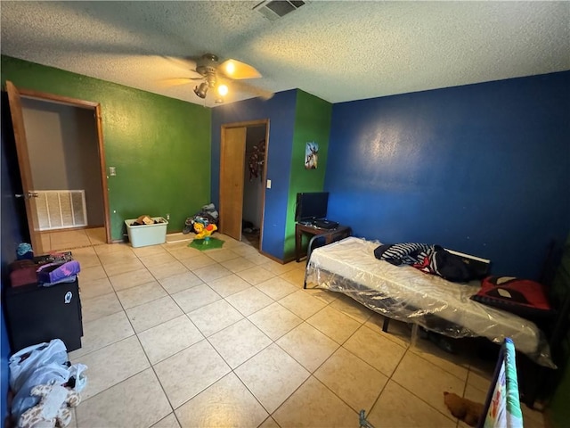 60 N Redwood Cir, Sallisaw, OK 74955 - bedroom featuring a textured ceiling, visible vents, ceiling fan, and tile patterned flooring