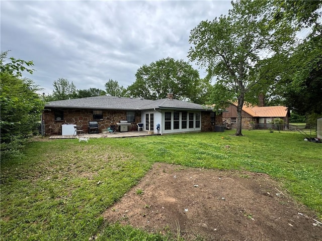 60 N Redwood Cir, Sallisaw, OK 74955 - rear view of property with a chimney, a patio area, a lawn, and stone siding