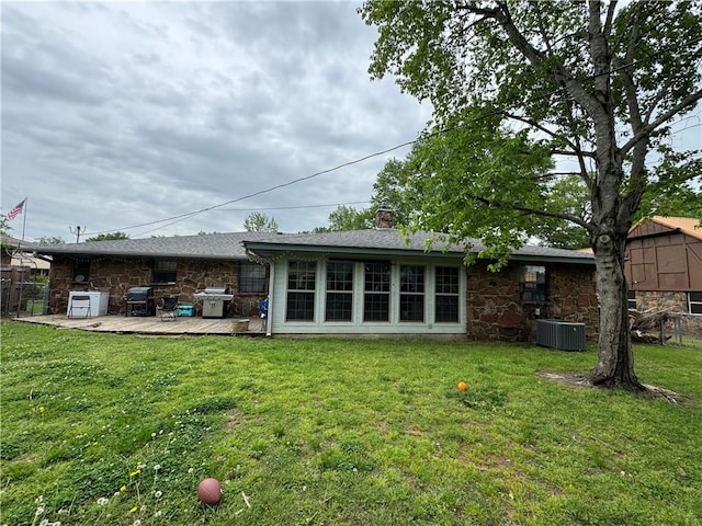 60 N Redwood Cir, Sallisaw, OK 74955 - back of property with a lawn, fence, a chimney, and stone siding