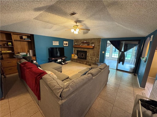 60 N Redwood Cir, Sallisaw, OK 74955 - living area featuring visible vents, a fireplace, a textured ceiling, a ceiling fan, and light tile patterned floors