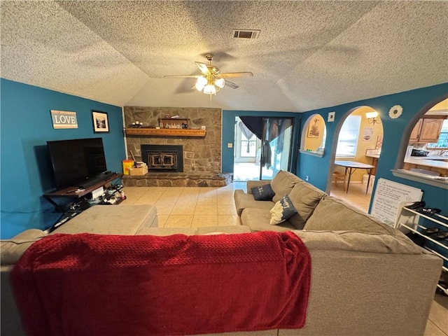 60 N Redwood Cir, Sallisaw, OK 74955 - living room featuring a ceiling fan, a textured ceiling, visible vents, a fireplace, and lofted ceiling
