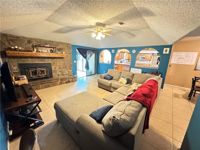60 N Redwood Cir, Sallisaw, OK 74955 - tiled living area featuring ceiling fan, a fireplace, a textured ceiling, lofted ceiling, and visible vents