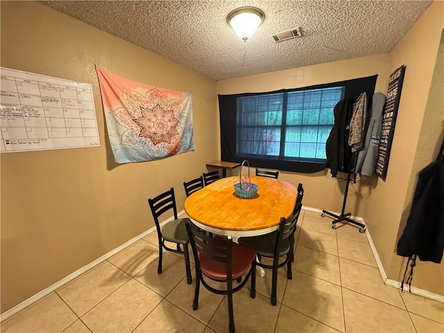 60 N Redwood Cir, Sallisaw, OK 74955 - dining area featuring baseboards, a textured ceiling, visible vents, and light tile patterned floors