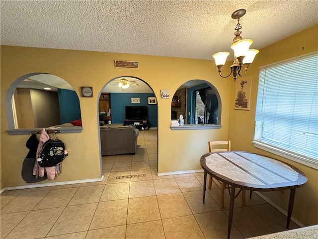 60 N Redwood Cir, Sallisaw, OK 74955 - tiled dining room with an inviting chandelier, visible vents, baseboards, a textured ceiling, and arched walkways