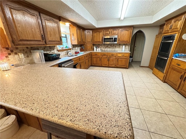 60 N Redwood Cir, Sallisaw, OK 74955 - kitchen with a sink, appliances with stainless steel finishes, a textured ceiling, and light countertops
