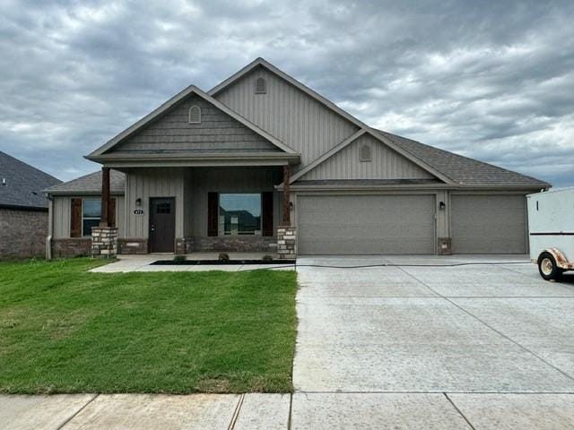 craftsman house featuring concrete driveway, board and batten siding, a front yard, and a garage