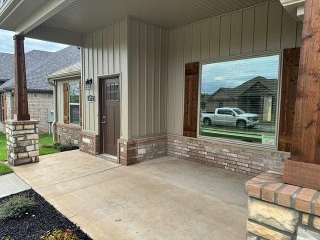exterior space with board and batten siding and a shingled roof