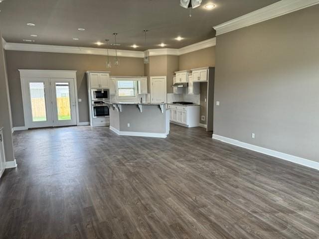 unfurnished living room featuring baseboards, ornamental molding, and dark wood-type flooring
