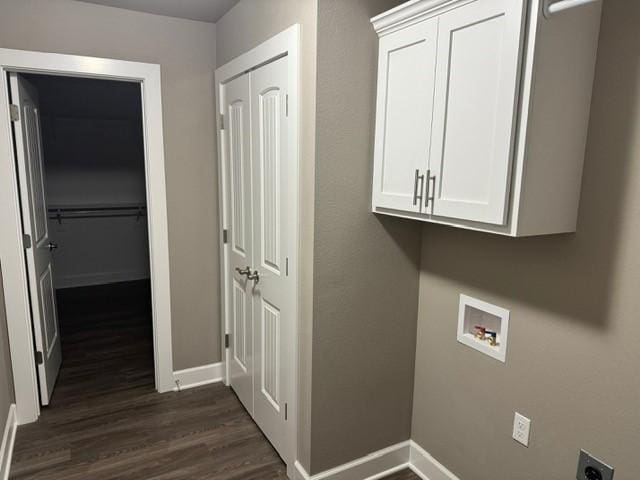 laundry area featuring cabinet space, hookup for a washing machine, baseboards, hookup for an electric dryer, and dark wood-style floors