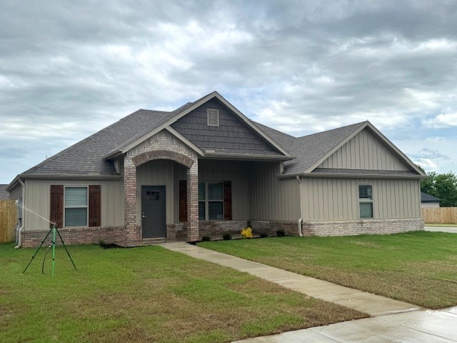 681 Baggett St, Prairie Grove, AR 72753 - craftsman house with a shingled roof, a front lawn, and brick siding