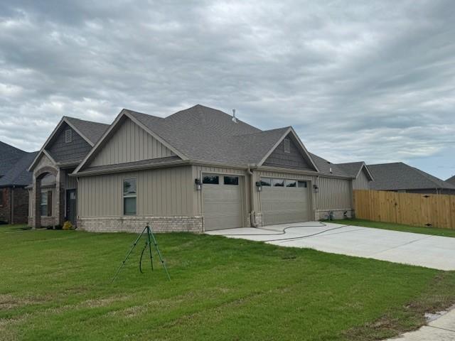681 Baggett St, Prairie Grove, AR 72753 - view of side of property featuring fence, an attached garage, board and batten siding, a lawn, and driveway