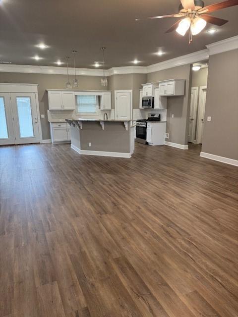 681 Baggett St, Prairie Grove, AR 72753 - unfurnished living room with crown molding, baseboards, a ceiling fan, and dark wood-style floors