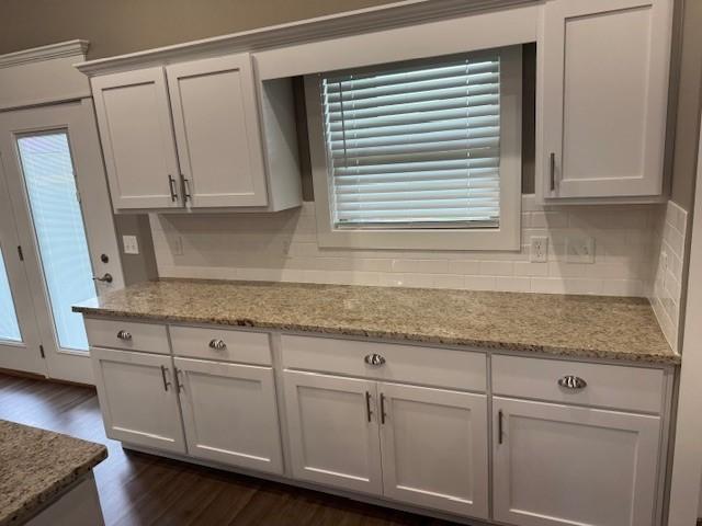 681 Baggett St, Prairie Grove, AR 72753 - kitchen featuring decorative backsplash, light stone countertops, dark wood-style flooring, and white cabinets