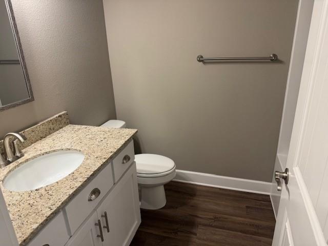 681 Baggett St, Prairie Grove, AR 72753 - bathroom featuring vanity, baseboards, wood finished floors, and toilet