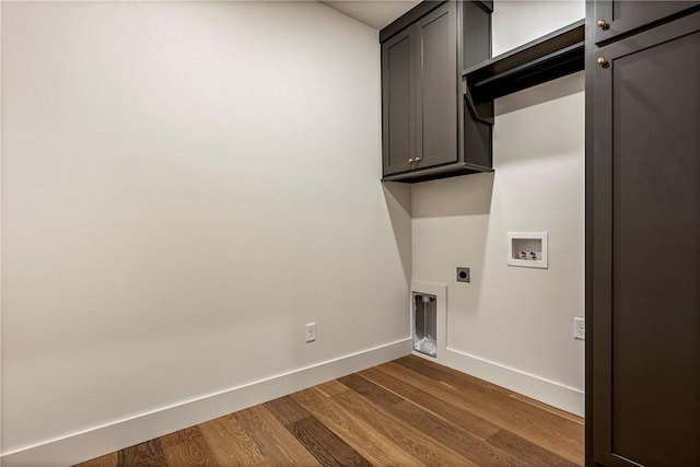 laundry area with electric dryer hookup, dark wood finished floors, cabinet space, baseboards, and hookup for a washing machine