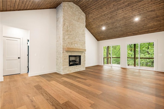 unfurnished living room with baseboards, high vaulted ceiling, wood finished floors, and wooden ceiling