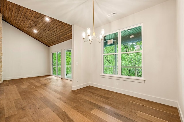 empty room with an inviting chandelier, baseboards, plenty of natural light, and visible vents