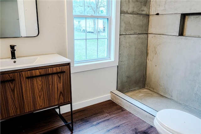 bathroom with vanity, baseboards, toilet, and wood finished floors