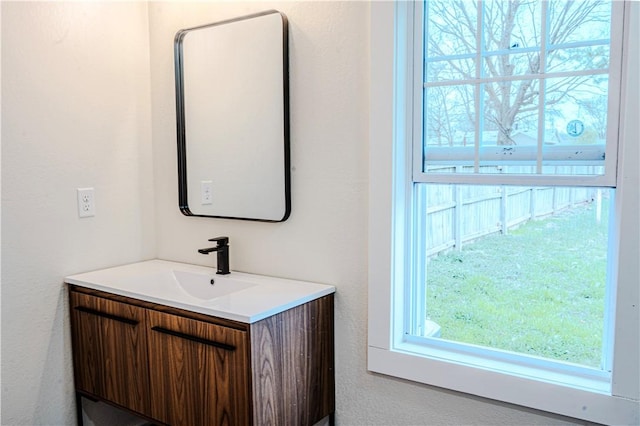 bathroom with vanity and a textured wall