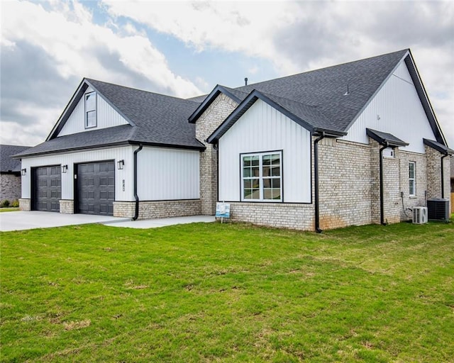 modern inspired farmhouse featuring central AC unit, an attached garage, driveway, and a front yard